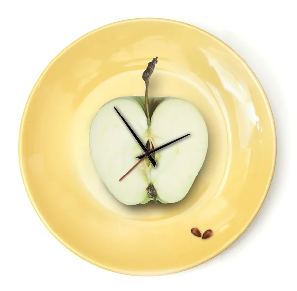 Reloj de manzana en el plato . —  Fotos de Stock