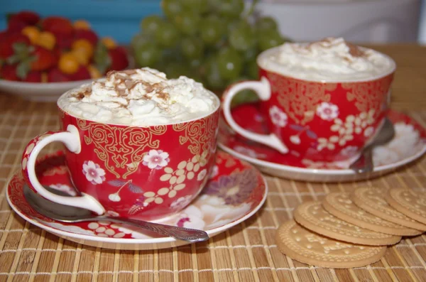 Two cups of cappuccino with cream