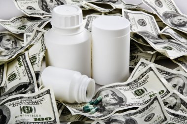 White bottles of medicine and dollars clipart