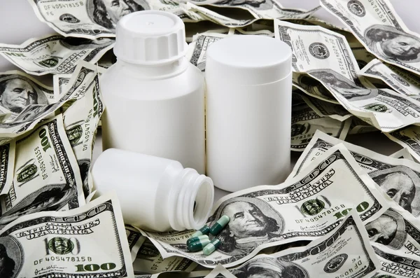 Stock image White bottles of medicine and dollars