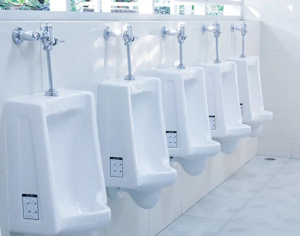 Modern restroom interior with urinal row — Stock Photo, Image