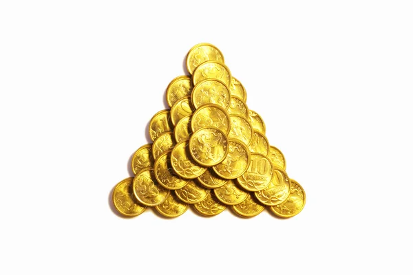 Triangular pyramid from coins of yellow metal — Stock Photo, Image