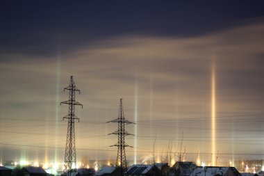 Columns of light from lanterns in the winter clipart