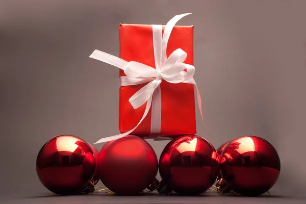 Present and christmas balls — Stock Photo, Image