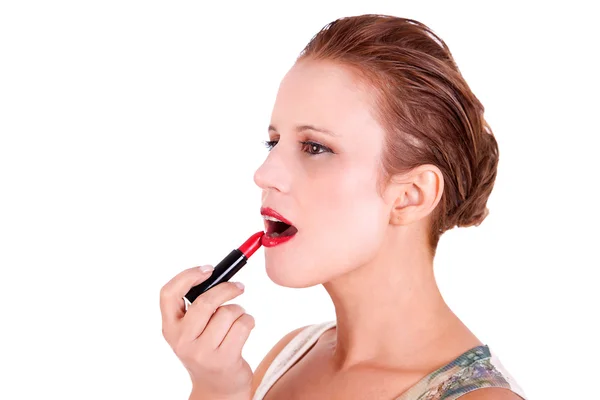 stock image Beautiful and happy middle-aged woman putting lipstick, isolated on white background, studio shot