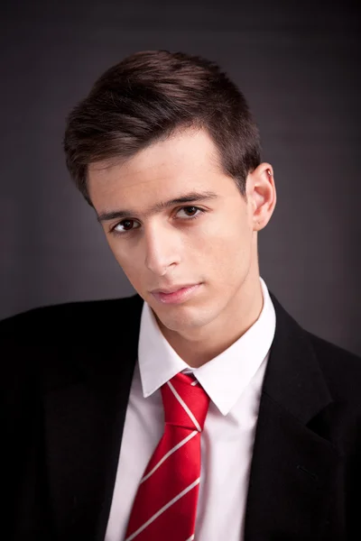 Portrait of a young and sad business man isolated on black background. Studio shot. — Stock Photo, Image
