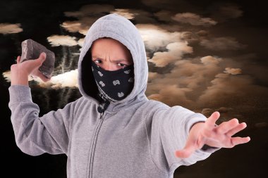 A teen with a rock, in a act of juvenile delinquency, with clouds of smoke background clipart