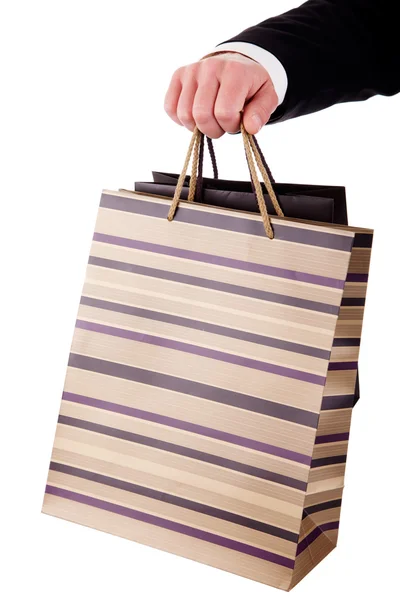 Detail of a hand of a man doing shopping,with bags isolated over a white background. Studio shot. — Stock Photo, Image