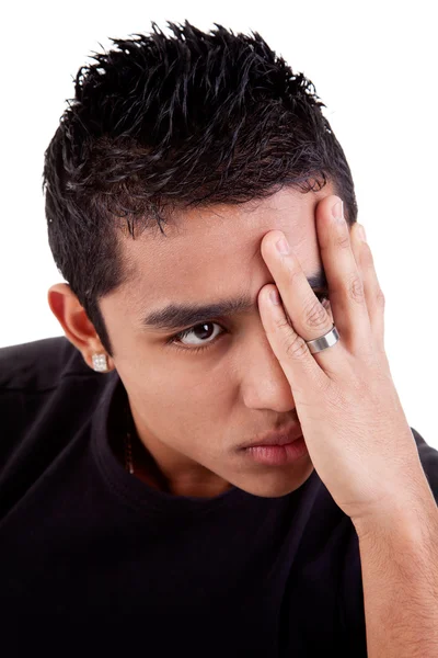 Young latin man, pensive, with his hand on front of eyes , isolated on white background, studio shot — Stock Photo, Image