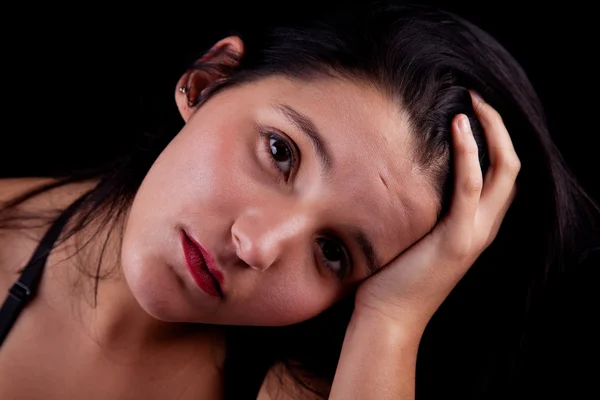 Thoughtful and sad pretty woman , isolated on black background. Studio shot. — Stock Photo, Image