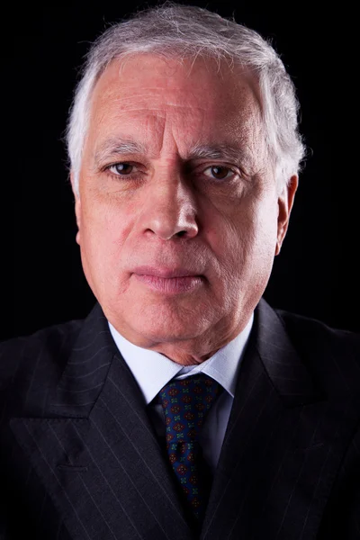 Portrait of a handsome mature businessman, on black background, studio shot — Stock Photo, Image