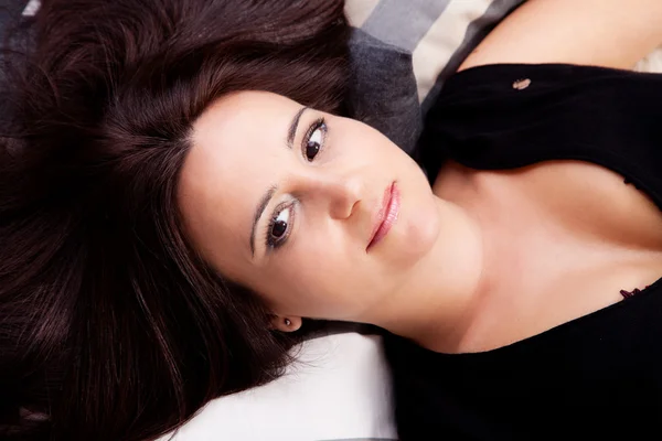 Beautiful and smiling middle-age woman lying — Stock Photo, Image