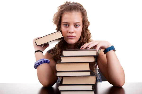 Serious and beautiful girl , with a stack of books, isolated on white. Studio shot — Stock Photo, Image