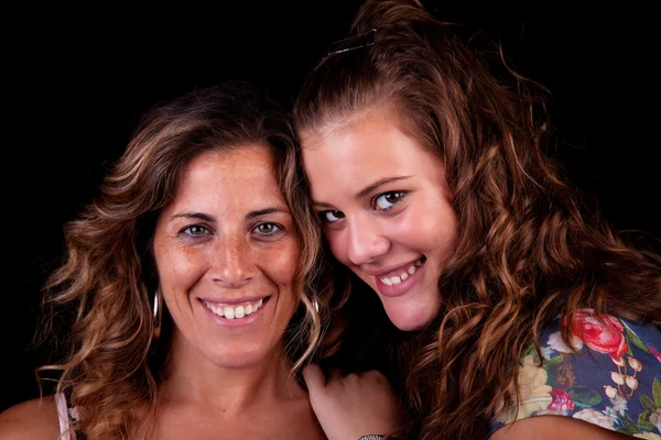 Happy mother and daughter, isolated on black. Studio shot — Stock Photo, Image