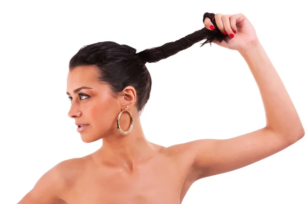 Beautiful woman holding her hair, on white, studio shot — Stock Photo, Image
