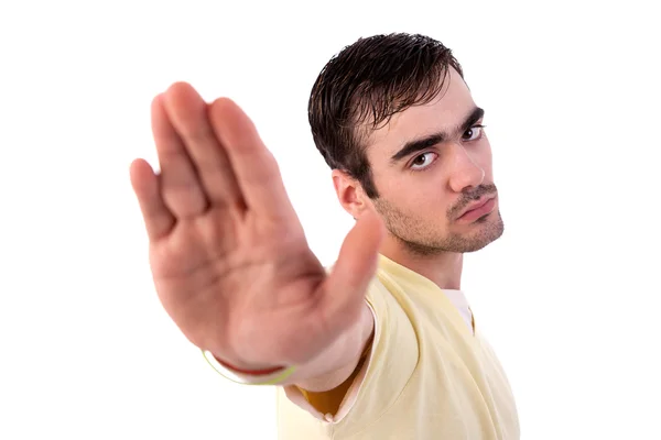 Молодий чоловік з рукою підняв сигнал, щоб зупинитися, ізольований на білому тлі, студійний знімок — стокове фото