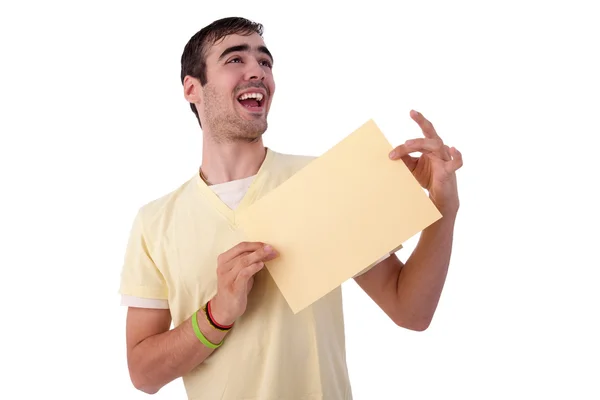 Young smiling man holding a yelow sheet of paper in his hand — Stock Photo, Image