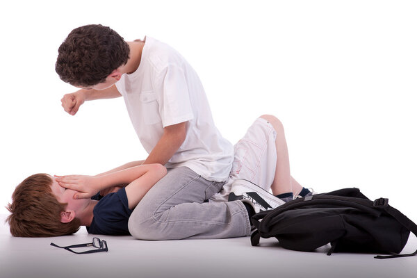 Child crying on the floor child being beaten by a teenager, isolated on white, studio shot