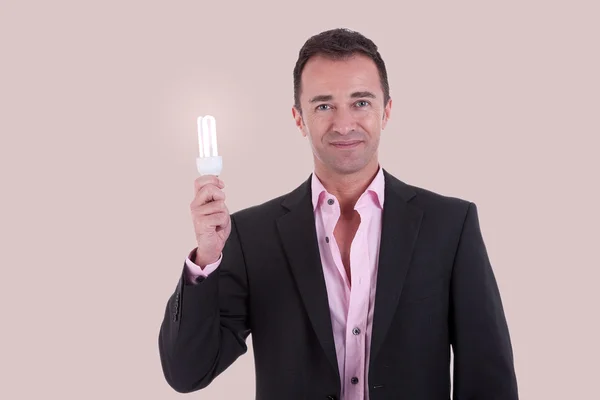Portrait of a business man with a light bulb, studio shot — Stock Photo, Image
