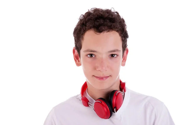 Young man standing listening to music on red headphones, isolated on white, studio shot — Stock Photo, Image