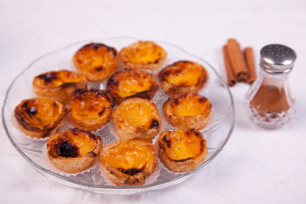 Pasteis de nata on a plate - traditional portuguese egg tarts - pastries