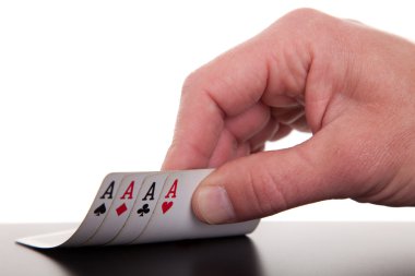 Man's hand revealing four aces, isolated on white background, studio shot clipart