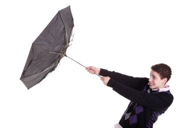 Young boy with an umbrella turned by the wind, isolated on white, studio shot clipart