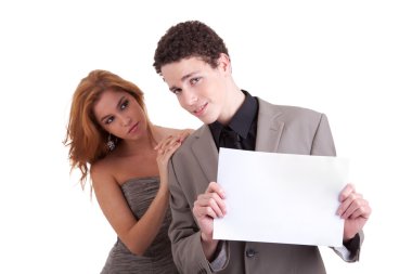 Young couple, man holding a paperboard in hand,she looking for him, isolated on white, studio shot clipart