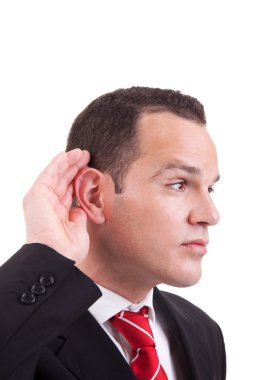 Businessman, listening, viewing the gesture of hand behind the ear, isolated on white background clipart