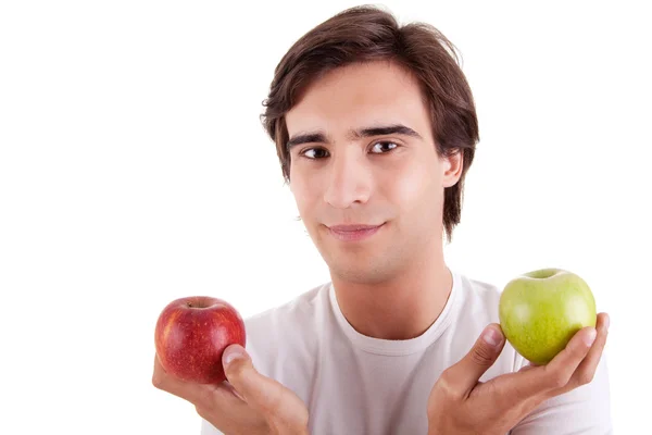 Retrato de un joven con dos manzanas en las manos: verde y rojo. Concepto de elección —  Fotos de Stock