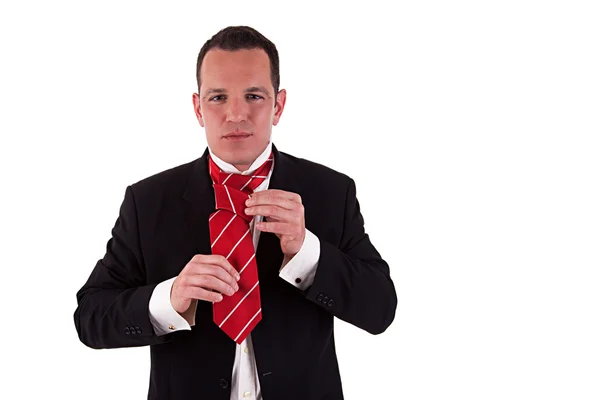Businessman putting on tie — Stock Photo, Image