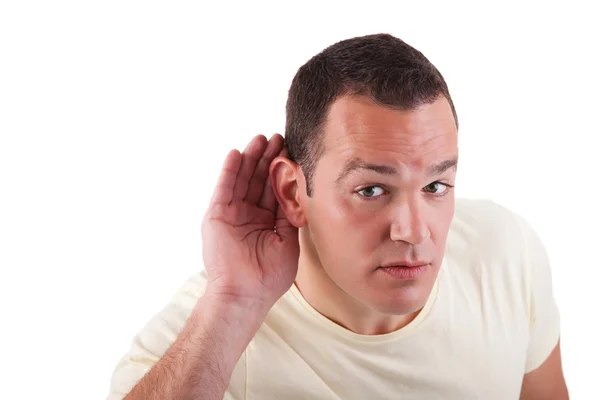 Mann hört zu, betrachtet die Handbewegung hinter dem Ohr, isoliert auf weißem Hintergrund — Stockfoto