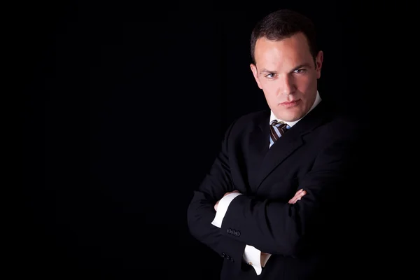 Portrait of a business man isolated on black background. Studio shot. — Stock Photo, Image