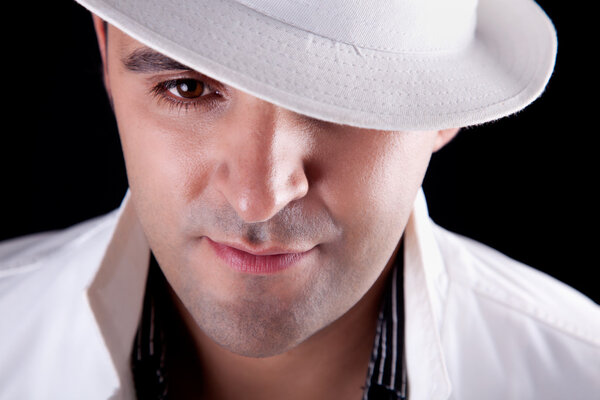 Portrait of a man with his white hat, isolated on black. Studio shot