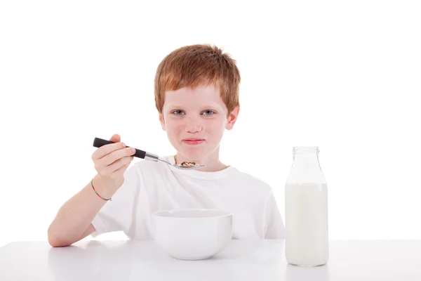 stock image Cute boy taking breakfast, isolated on white, studio shot