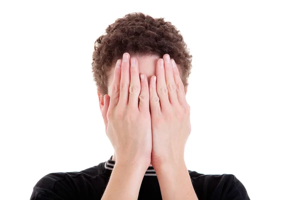 Jonge man die betrekking hebben op zijn gezicht, geïsoleerd op wit, studio opname — Stockfoto