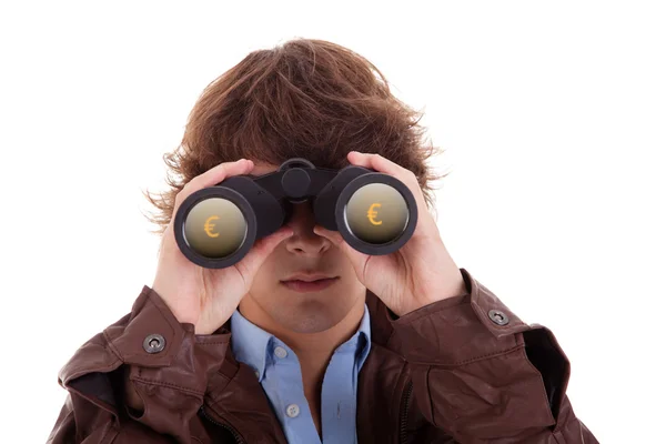 Young man looking through binoculars, with symbol of money, isolated on white, studio shot — Stock Photo, Image
