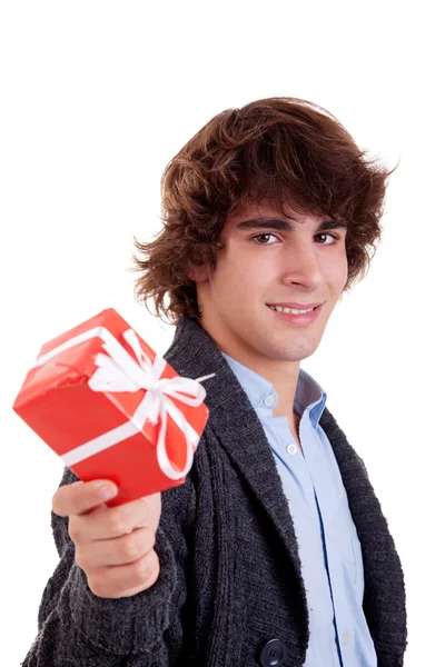 Χαρούμενος νεαρός, με ένα κόκκινο δώρο που απομονώνονται σε λευκό φόντο, studio που γυρίστηκε. — Φωτογραφία Αρχείου