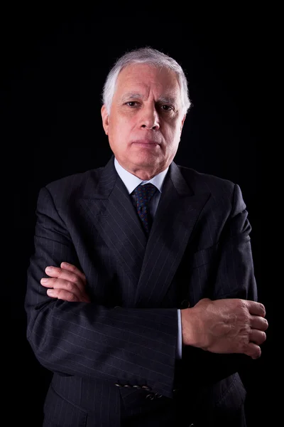 Portrait of a handsome mature businessman, thinking, on black background, studio shot — Stock Photo, Image