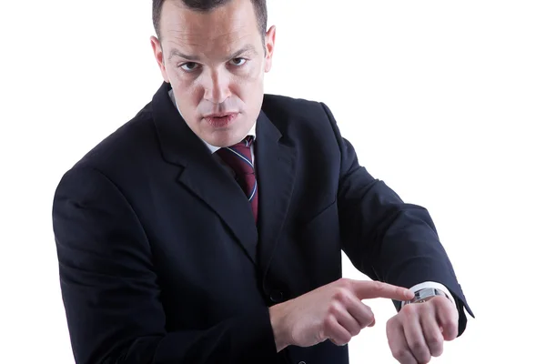 Geschäftsmann zeigt auf die Uhr, isoliert auf weißem Hintergrund. Studioaufnahme. — Stockfoto