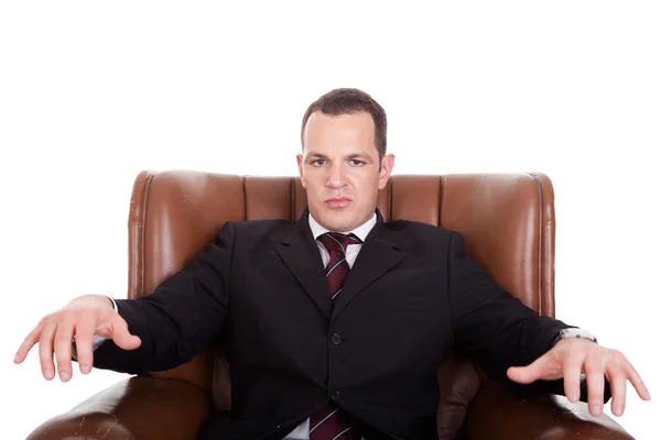 Businessman upset seated on a chair, isolated on white background. Studio shot. — Stock Photo, Image
