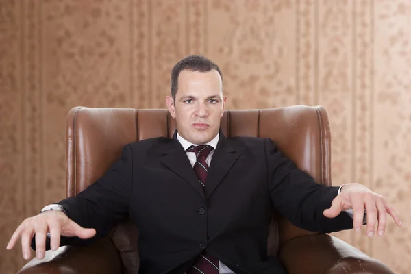 Businessman upset seated on a chair, — Stock Photo, Image