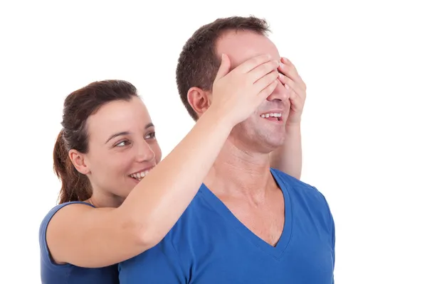 Portrait of a happy woman covering his man eyes, to surprise him Stock Photo