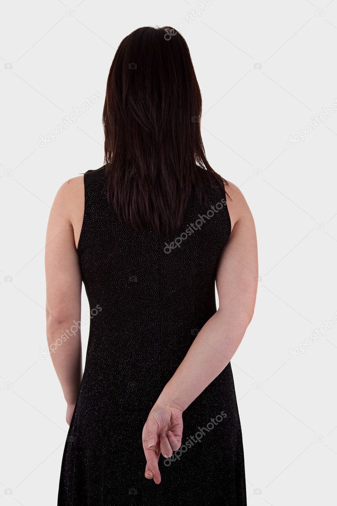 Young woman seen from behind, his hands back, her fingers crossed
