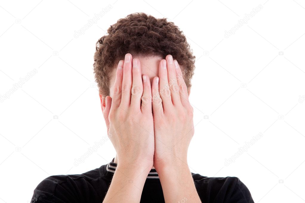 Young man covering his face, isolated on white, studio shot