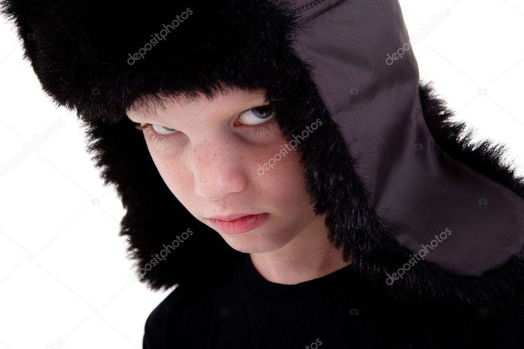 Cute boy with a cap, bored, isolated on white background, studio shot.