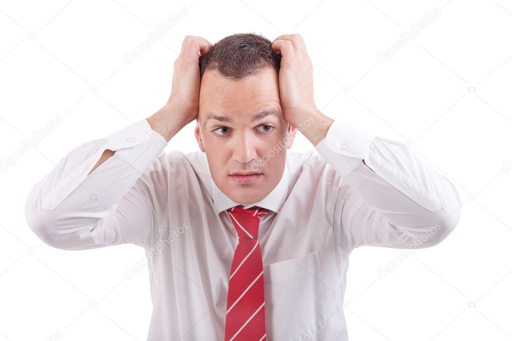 Strongly afflicted business man, with hands on head, isolated on white
