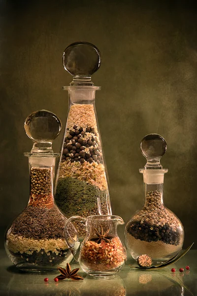 Still Life with spices in glass flasks — Stock Photo, Image