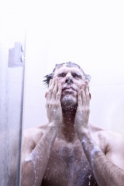 Young Man bathing under an shower clipart