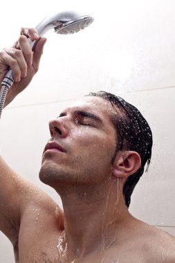 Young Man bathing under an shower clipart